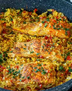 chicken and rice in a skillet with parsley on the side, ready to be eaten