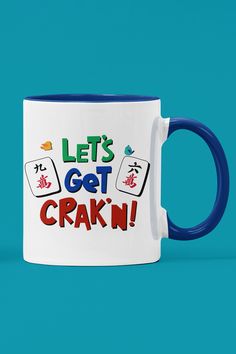 white ceramic mug with a blue handle and interior. The image on the mug says Lets get crakn and has 2 Mahjong crak tiles. Sewing Projects, Coffee Mug, Coffee Mugs, Great Gifts, Ships, Mug, Let It Be, Coffee, Funny