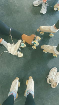 several people with skateboards standing in a circle