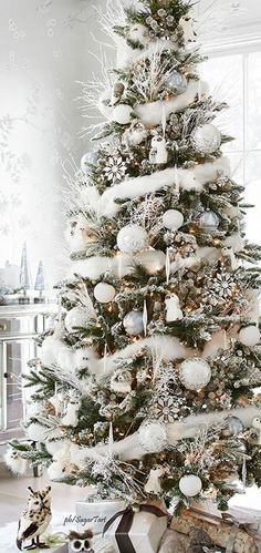 a white christmas tree with snow on it