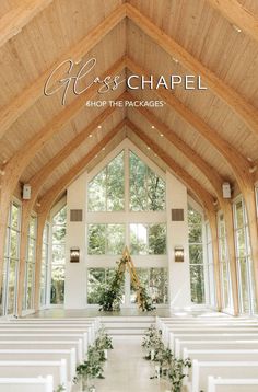 the inside of a church with white pews and greenery