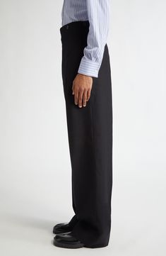 The maison brings its signature unconventional vision to wardrobe-essential wool trousers refreshed in a vintage-inspired high-waisted silhouette. 35 1/2" inseam; 25" leg opening; 17" front rise; 21" back rise (size 48EU) Zip fly with button closure Side-seam pockets; back button-welt pocket Martingale belt 100% wool Dry clean Made in Italy Designer Clothing Wool Trousers, Fabric Gift Bags, Fabric Gifts, Anniversary Sale, Free Fabric, Black Fits, Print Gifts, Welt Pocket, Wardrobe Essentials