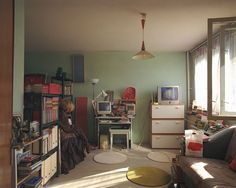 a living room filled with furniture and lots of clutter on top of the floor