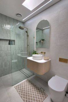 a bathroom with a toilet, sink and shower