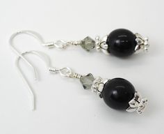 "Stunning Swarovski Crystal 8mm crystal pearls or Czech Druk beads with sparkling Swarovski crystals and silver contrasting accents handcrafted on sterling silver French ear wires. These beautiful earrings shimmer like only Swarovski can! Finished length is about 1\". The pink and white earrings are genuine Swarovski crystal pearls. The black pair is made with Czech highly polished Druk beads in shiny opaque black. The purple beads are Czech Druk beads in a matte finish. All are stunning and ver Elegant Silver Czech Glass Jewelry, Elegant Earrings With Spacer Beads For Gift, Elegant Dangle Earrings With Spacer Beads, Silver Earrings With Polished Beads For Gift, Beaded Earrings Black, Swarovski Beads, Swarovski Crystal Beads, Beads Online, Earrings Black