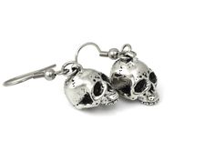 We wanted these skulls to be a little more realistic and spooky than our other human skull earrings and we think that we pulled it off nicely! The design was carved by hand in wax and then molded and cast in metal. The skull charms are cast in Lead Free Pewter and weighs a bit under 5 grams each. They are about 13 mm long (just over half an inch) and dangle from Stainless Steel earring hooks. They are oxidized to fill in the details and then polished. For more of our skull earrings please look h Bird Skull Necklace, Raven Skull Necklace, Metal Goth, Jewelry Halloween, Shiny Objects, Halloween Charms, Bird Skull, Goth Jewelry, Symbolic Jewelry