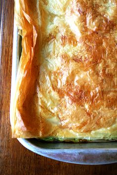 a square casserole dish is covered with cheese