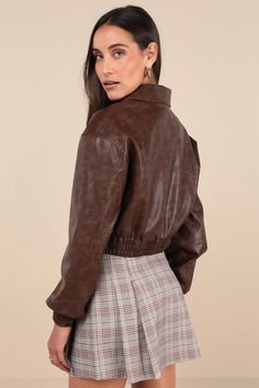 Hit the road looking cuter than ever in the Lulus Iconic Travels Brown Vegan Leather Cropped Bomber Jacket! Pebbled faux leather, with distressed fading throughout, shapes this stylish jacket with a collared neckline and long sleeves with drop shoulders and fitted elasticized cuffs. An exposed silver zipper secures at the front of the cropped bodice that boasts two, seamed zippered front pockets. Classic, elasticized banded hem completes the look. Pair with the matching skort for a complete look Trendy Collared Biker Jacket For Spring, Trendy Faux Leather Collared Jacket, Trendy Brown Cropped Jacket For Fall, Spring Collared Leather Jacket, Trendy Collared Faux Leather Outerwear, Distressed Brown Long Sleeve Outerwear For Fall, Casual Distressed Brown Fall Outerwear, Spring Collared Faux Leather Outerwear, Trendy Collared Biker Jacket For Fall