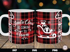 two red and black plaid coffee mugs with santa claus is coming to town on them