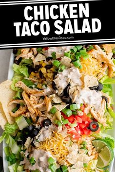 this chicken taco salad is loaded with shredded cheese, black olives, lettuce and tomatoes