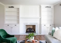 a living room filled with furniture and a fire place in the middle of a room