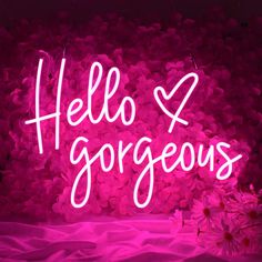 a pink neon sign that says hello gorgeous