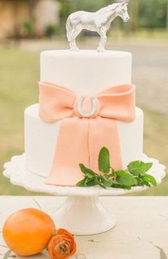 a wedding cake with a horse on top