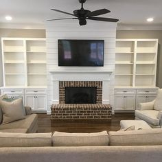 the living room is clean and ready to be used as a family room with built - in bookcases