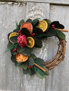 This lovely Holiday wreath is made on an 8"vine wreath, is about 10" across  and decorated with preserved  green populus eucalyptus, cedar, dried orange slices, quince, a dried red artichoke and cinnamon sticks.  Everything in this real is real! Eucalyptus is very limited this year, purchase these early! The perfect size for an apartment door or a very special gift!  Use n your kitchen or dining room year round! This is a one of a kind wreath. Keep away from moisture, is not for outside use. My Dried Floral Wreath, Dried Floral Wreaths, Wreath Eucalyptus, Fruit Wreath, Preserved Eucalyptus, Apartment Door, Vine Wreath, Dried Orange Slices, Eucalyptus Wreath