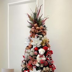 a christmas tree decorated with teddy bears and bows