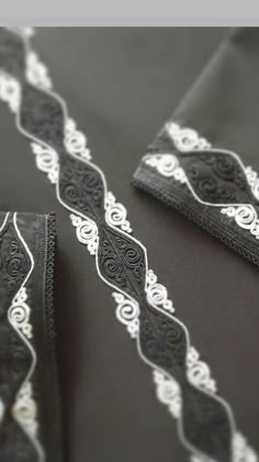 black and white lace on the side of a dress with an intricate design in it