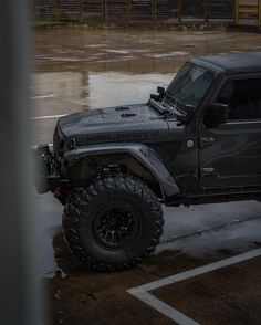 a black jeep parked in a parking lot