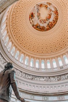 a statue in the center of a domed room