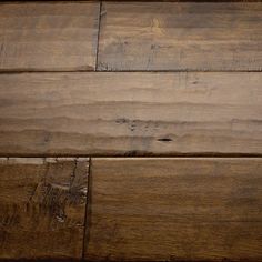 an old wooden floor with peeling paint on the top and bottom part of it's surface