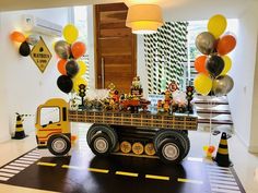 a construction truck birthday party with balloons and decorations