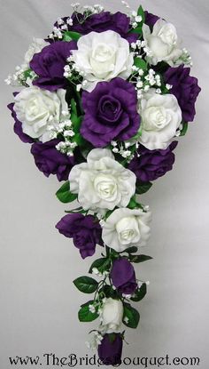 purple and white bridal bouquet with baby's breath in the center on a white background