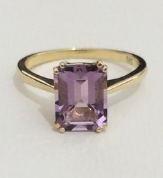 This stunning cocktail ring is set with a luscious, purple amethyst, which really flashes and flickers with vibrant violet reflections! Set into a lovely vintage mounting with simple. This ring is a beautiful addition to anyone's collection. Metal: 14K Yellow Gold Gem: Amethyst 0.36 x 0.28 inch (9.2 x 7.2 mm) Weight: 2.8 gr. -------------- Material options ------------------ - 14k and 18k White gold and Yellow gold, Platinum, and sterling silver - Can be made with different size Gemstones (Ask f Yellow Gold Amethyst Ring With Emerald Cut, Luxury Purple Amethyst Ring, Rectangular Shape, Luxury Purple Amethyst Rectangular Ring, Luxury Purple Rectangular Amethyst Ring, Purple Emerald-cut Ring For Formal Occasions, Purple Emerald Cut Ring For Formal Occasions, Formal Purple Rings With Rectangular Stone, Formal Purple Emerald Cut Ring, Rectangular Amethyst Ring In 14k Gold