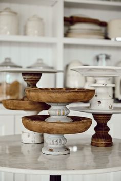 several plates stacked on top of each other in a room with white walls and shelves