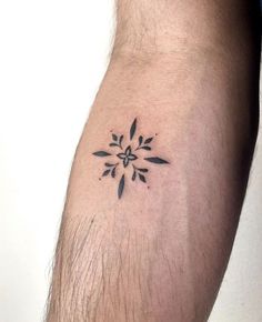 a man's arm with a small tattoo design on the left side of his arm