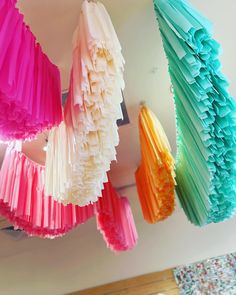 multicolored paper fans hanging from the ceiling