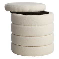 a stack of white pillows sitting on top of each other