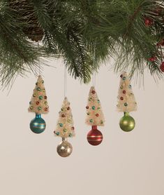 an ornament hanging from a tree decorated with christmas balls and baubles