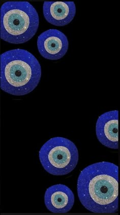 several blue and silver circles with black dots on the middle one has an eyeball in it