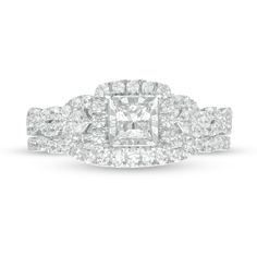 Celebrate your love with the elegant design of this princess-cut diamond twist bridal set. Crafted in 10K white gold The engagement ring showcases a 1/3 ct. princess-cut diamond - artfully set to enhance size and sparkle - wrapped in a cushion-shaped frame of diamonds. Shimmering princess-cut diamonds flank the center while the twist split ribbons of the split shank glisten with diamonds. Underneath, a pair of bezel-set diamonds adorn the 10K rose gold gallery. On your wedding day, the contoured Center Stone Engagement Ring, Gold Gallery, Gold Book, Diamond Frame, Bezel Set Diamond, Stone Engagement Rings, Split Shank, Bridal Set, Princess Cut Diamonds