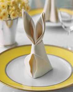 an origami rabbit sitting on top of a white plate