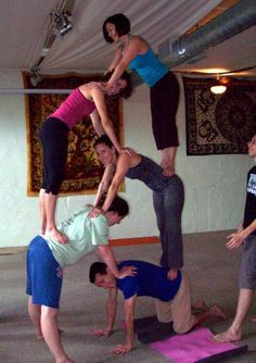 a group of people doing yoga in a room