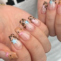 These nails feature a playful mix of leopard print tips, pastel blue stars, and cute pink bows, capturing the fun and vibrancy of summer.  🌸Click on the image to shop our trending Korean Gel Polish this season.  🌸Credit: gang_nailz on Instagram 🌸summer nails, trendy nails, Korean gel polish, animal print nails, star nail designs, pastel nails, cute nail art, summer nail trends, leopard print nails, bow nail art, glitter nails, fun nails, summer manicure, nail designs, nail inspiration, Instagram nails, stylish nails, colorful nails, nail fashion Nail Designs Pastel, Nails Gyaru, Korean Gel Polish, Gyaru Nails, Star Nail Designs, Cheetah Print Nails, Cheetah Nails, Leopard Print Nails