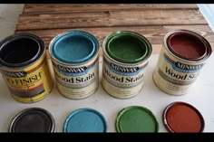 several cans of paint sitting on top of a table