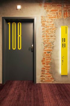 an image of a door with the number 108 on it in front of a brick wall