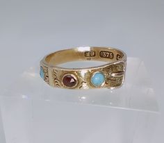 A totally delightful example of a antique Victorian period buckle band ring set with turquoise and garnet.  The ring looked like it's been made to fit a smaller finger at some point - see pics- however all is completely solid. Other than that superb condition. Fully hallmarked for 9ct gold 1860's Ring size UK J. US 5 The band is 0.5cm at the widest point and sits at 0.2cm off the finger Lovely Ring, Multi Stone, Multi Stone Ring, Blue Diamond, Gold Style, Stone Rings, Gold Chains, Ring Sets, Beautiful Earrings