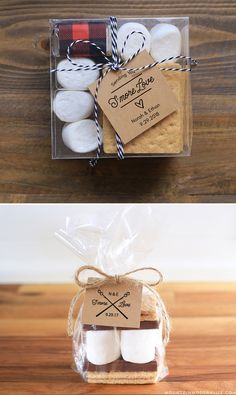 two boxes filled with cookies and marshmallows on top of a wooden table