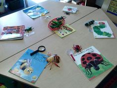 children's books and craft supplies on a table in a school library or classroom