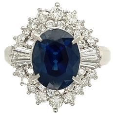 For Sale on 1stDibs - Simply Beautiful! Blue Sapphire and Diamond Art Deco Revival Platinum Ring. Centering a securely set Oval Sapphire, weighing approx. 3.34 Carat, surrounded Art Deco Sapphire Jewelry Gia Certified, Gia Certified Sapphire Cluster Jewelry, Gia Certified Oval Collectible Ring, Vintage Gia Certified Sapphire Jewelry, Collectible Oval Sapphire Ring In Platinum, Collectible Oval Sapphire Ring With Diamonds, Oval Sapphire Ring With Diamonds For Collectors, Collectible Oval Sapphire Diamond Ring, Blue Platinum Jewelry For Collectors