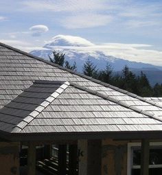 the roof of a house with mountains in the background