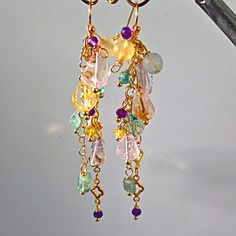 Make a glamorous statement on your wedding day with these exquisite Statement OOAK Wedding Earrings. Crafted with care and precision, these long multi-gemstone waterfall cascade tassel chain earrings in 18K Gold Plating are the epitome of boho bridal jewelry. Each piece is handmade with genuine, natural gemstones, ensuring both luxury and authenticity. The vibrant multicolor beads, featuring pastel blue, yellow, pink, and purple hues, add a delightful touch of color and charm to your ensemble. ? Boho Bridal Jewelry, Bleu Pastel, Yellow Citrine, Boho Bridal, Pink Amethyst, Earrings Long, Purple Hues, Handmade Boho, Gold Plated Chains