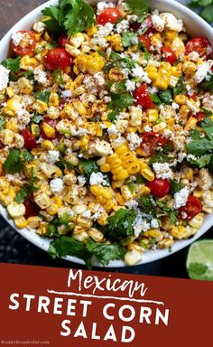 mexican street corn salad in a white bowl with cilantro, tomatoes and feta cheese