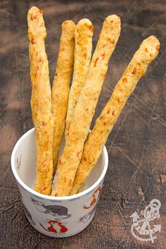 some kind of food that is in a bowl on a wooden table with chopsticks sticking out of it