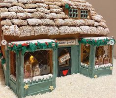 a ginger shop is decorated for christmas with snow and icing on the top roof