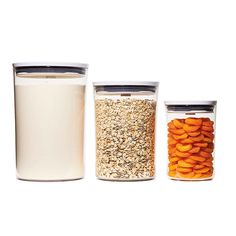 three jars filled with different types of food next to each other on a white surface