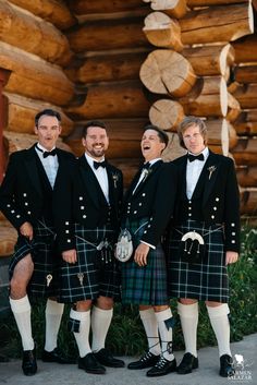 a group of men in kilts standing next to each other with their mouths open